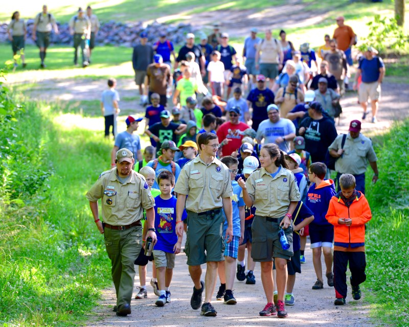 A group of staff and Scouts walking down a dirt trail