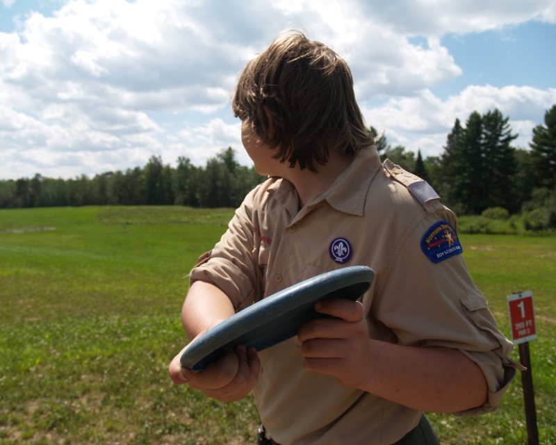 A Scout winding up to throw a disc