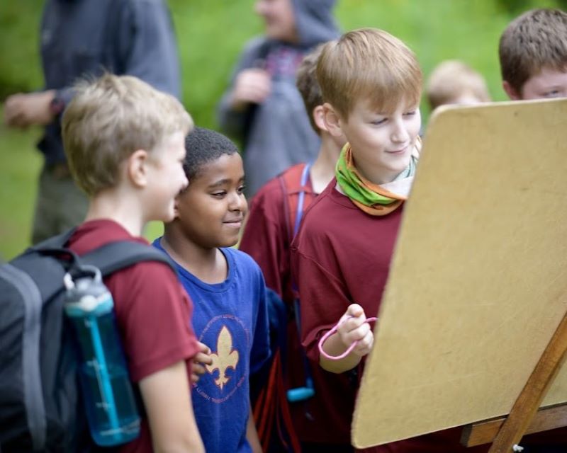 Scouts convene at a whiteboard