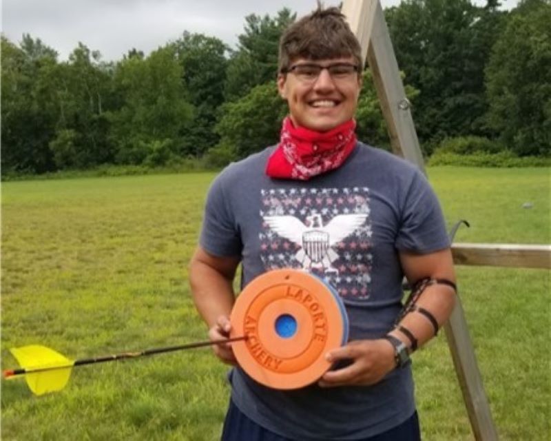 A proud archer holds his foam prey