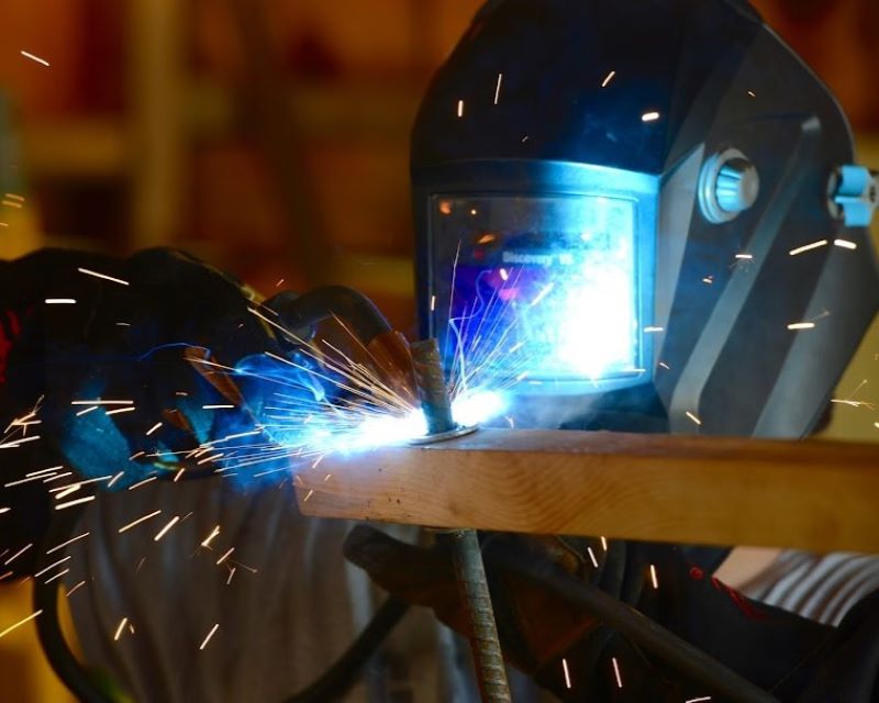 Sparks erupt as a scout welds their project